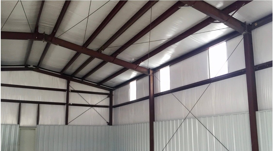 Interior view of a commercial building highlighting wall insulation installation.