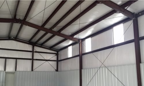 Interior view of a commercial building highlighting wall insulation installation.