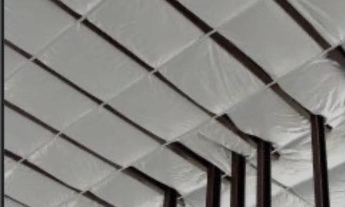 Interior view of a commercial building highlighting wall insulation installation.